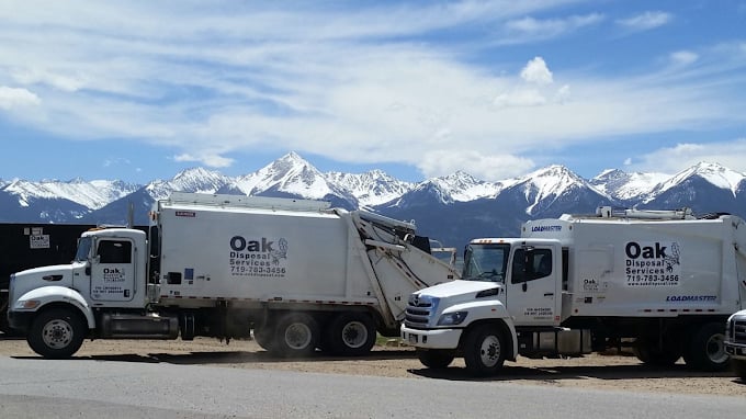 garbage trucks in front of mountains garbage trucks in front of mountains
